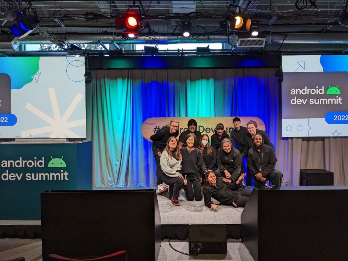 Production team on the Android Developer Summit 2022 stage, with event displays behind them.