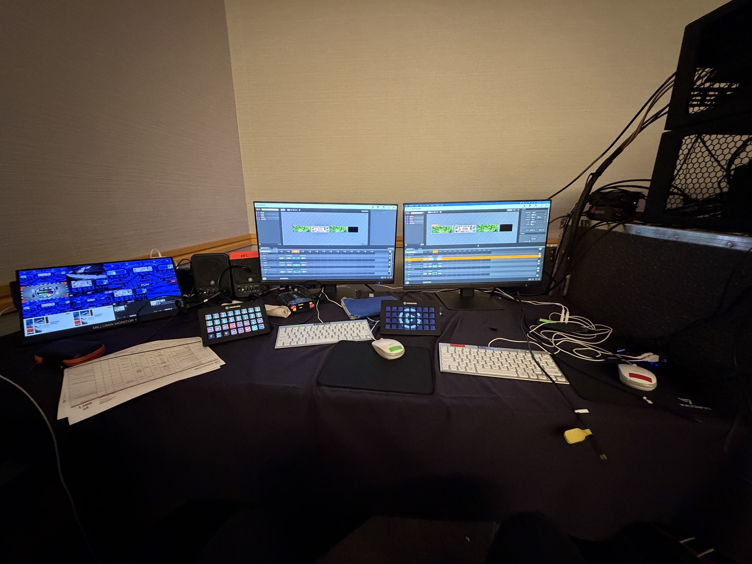 A redundant Millumin playback position with two control monitors, keyboards, and control surfaces.