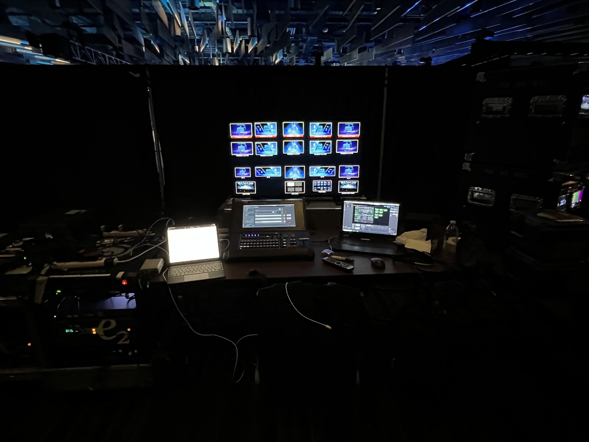 A video control position with a multiview display, switching console, and control laptops.