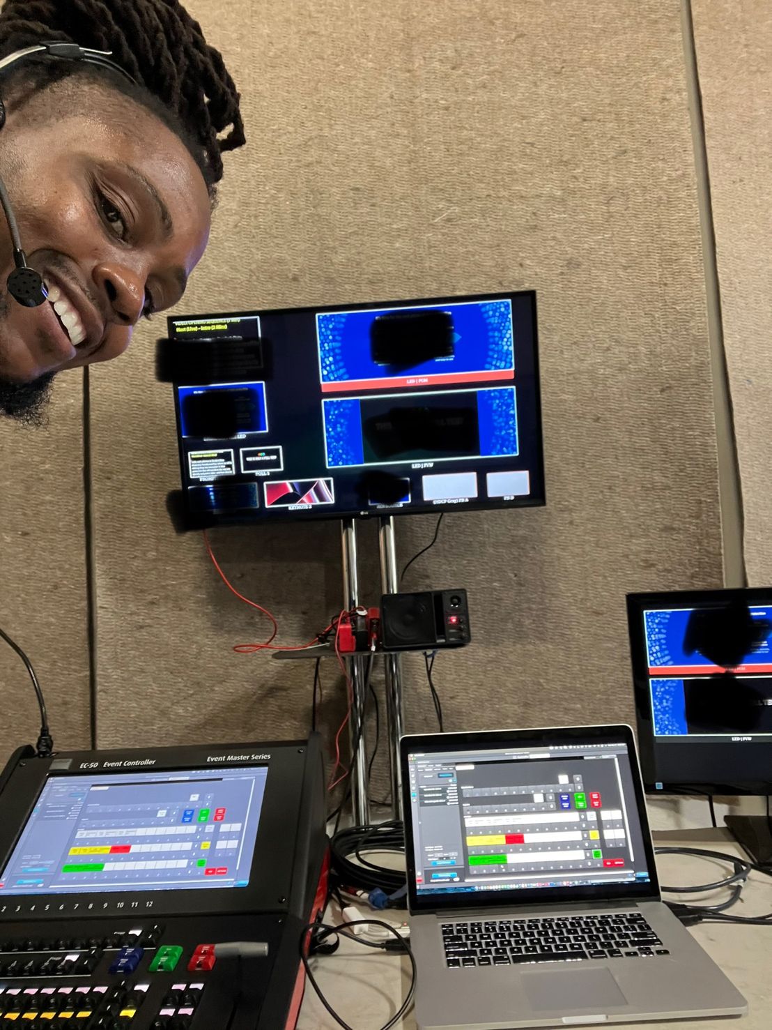Video position with an Event Master EC-50 control surface, laptop, and multiview displays.