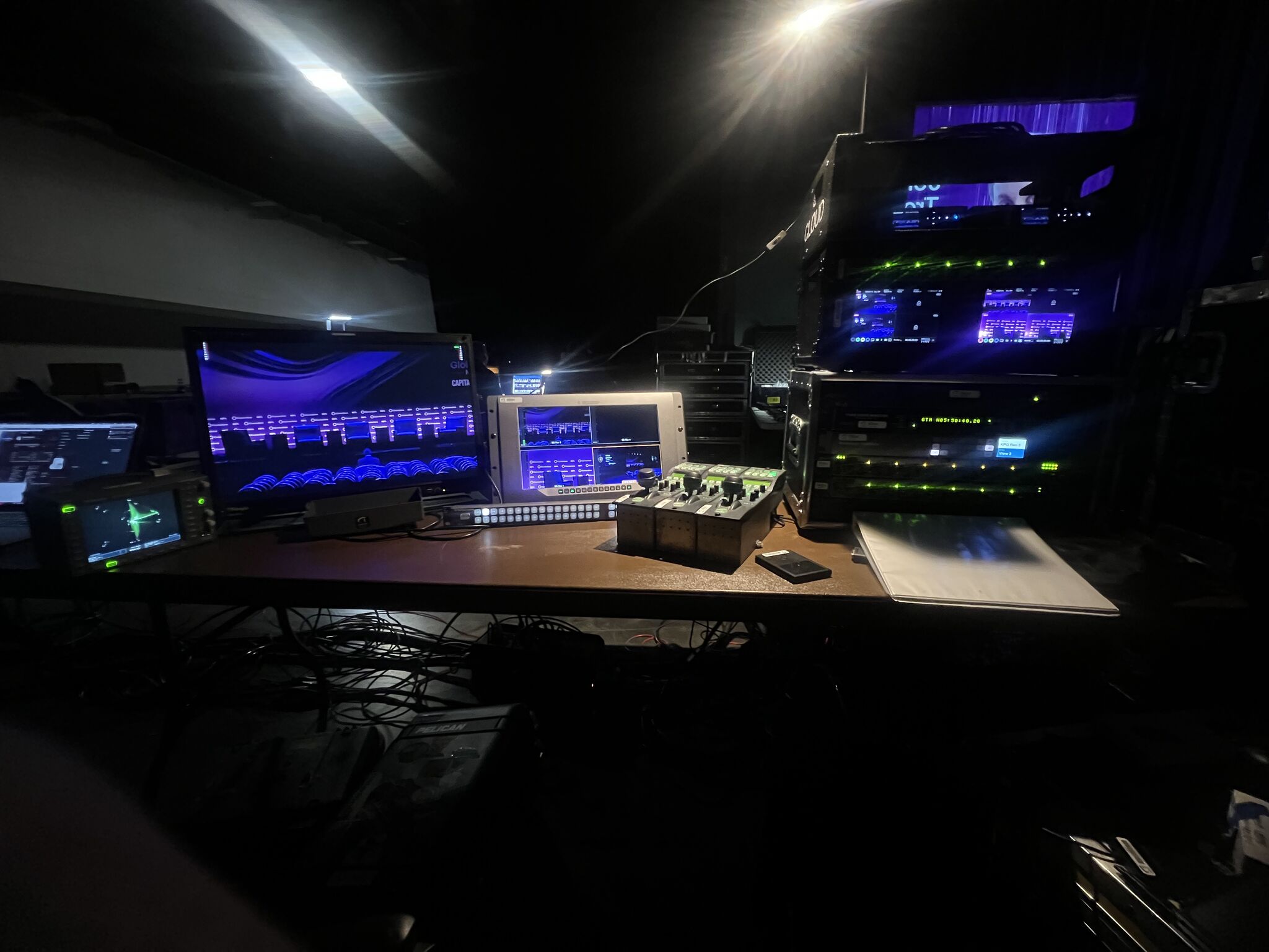Video monitors, control surfaces, and equipment racks at a live-event video position.